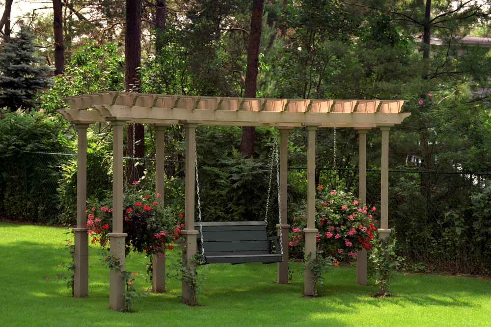 Wooden pergola with a black swing