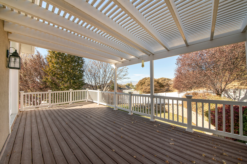 Designing Outdoor Bliss: Tips for Integrating Pergolas into Your Home's Aesthetic terrace,of,a,house,with,pergola,roof,and,wood,planks